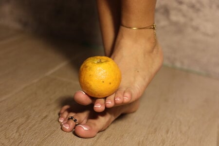 goddessfeetxx squashing a tangerine Pic 4