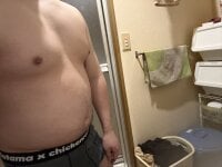 Stroking his big cock at a urinal